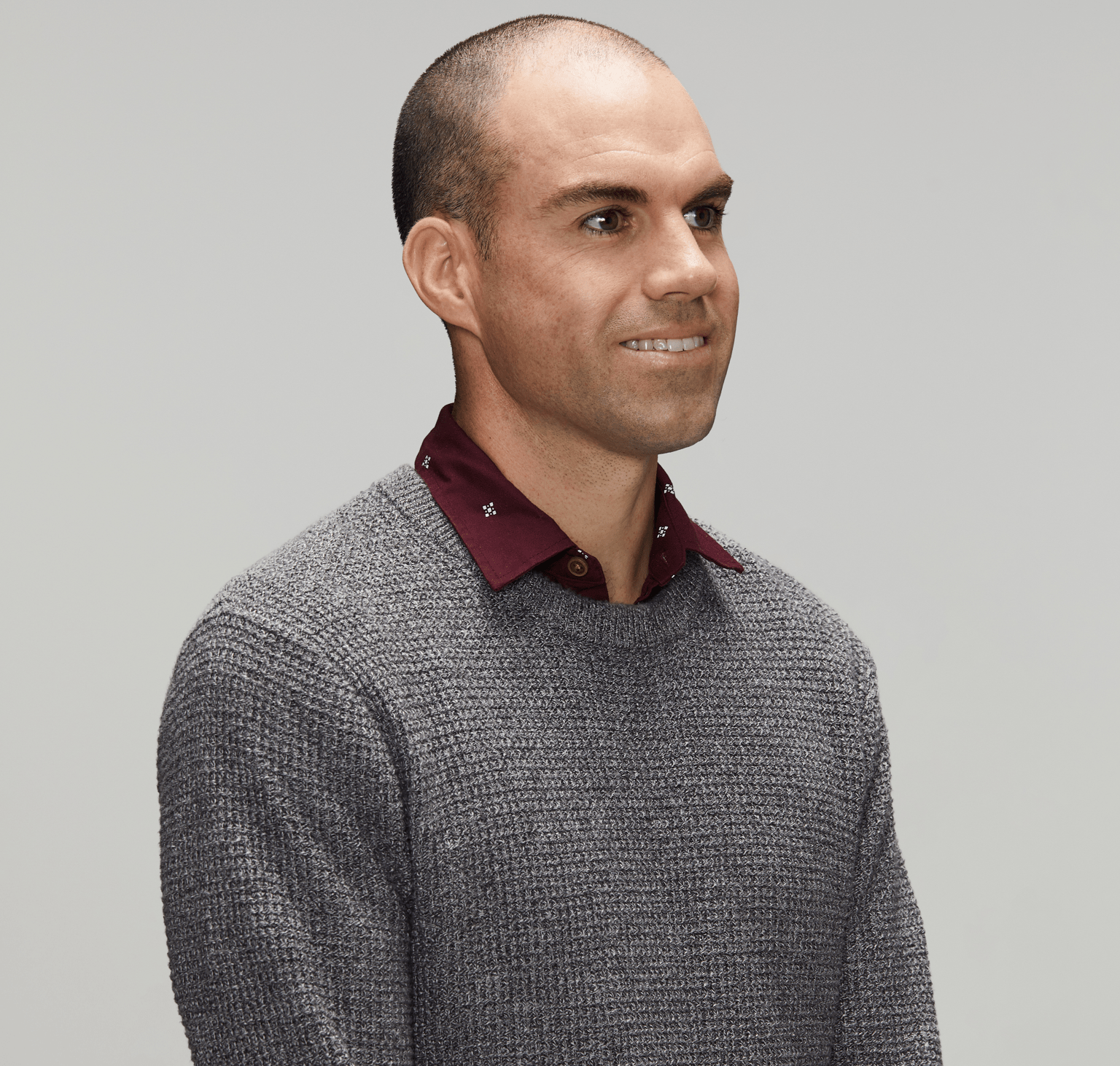 Police officer wearing smart casual clothes looking to right of camera; white male early to mid-thirties